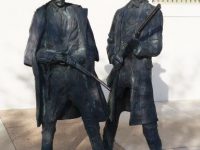 MYSTERY: Where is the location of these statues of two gunfighters?