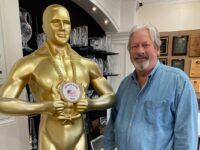 Chris West and a tall gold statue